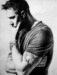 a pencil drawing of a man with tattoos on his arm and hand near his face