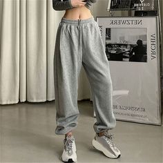 These Baggy Casual Jogging Sweatpants for Women are perfect for your everyday look. They feature a pleated front and a high waist for a comfortable fit. The solid pattern and pockets provide added decoration, while the drawstring closure ensures a secure fit. Made of Polyester fabric, these sweatpants have a medium stretch elasticity and are loose-fitting, offering a plush style. Specification: Front Style: Pleated Waist Type: High Pattern Type: Solid Decoration: Pockets Closure Type: Drawstring Trendy Baggy Harem Pants, Comfortable Leisure Bottoms In Solid Color, Trendy Solid Joggers With Tapered Leg, Leisure Harem Pants With Pockets, Winter Solid Color High-waisted Pants, Casual High-waist Winter Bottoms, Winter High-waisted Solid Color Bottoms, Solid Color High-waisted Pants For Winter, Casual High Waist Winter Bottoms