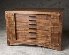 a wooden cabinet with five drawers on it