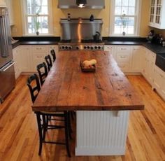 a kitchen with an island and table in it