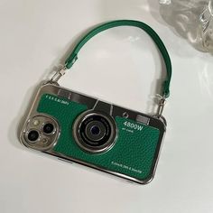 a green camera sitting on top of a white table