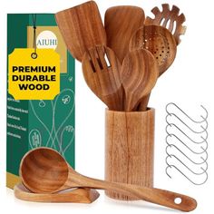 wooden utensils and spoons are in a holder next to a box with the lid open