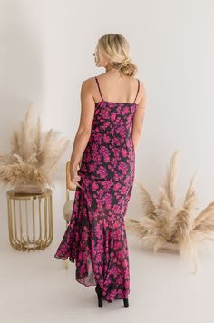 Stand out from the crowd in the fun and flirty Toya dress! This stunning fuchsia maxi features a bold floral print and an asymmetrical ruffle skirt for a playful twist. Perfect for spring and summer weddings. Details & Fit: 100% Polyester Runs True to Size Hand Wash Cold Hang To Dry V-Neckline Sleeveless Adjustable Straps Back Zipper Closure Asymetrical Ruffle Skirt Lined Floral Print Design Fuchsia | Black | Printed Model is 5'9" and wearing a size Small Chic Maxi Dress With Ruffles And Mermaid Hem, Summer Maxi Dress With Ruffles And Mermaid Hem, Summer Flirty Maxi Dress With Ruffled Skirt, Pink Flowy Midi Maxi Dress, Pink Flowy Maxi Dress With Midi Length, Pink Flowy Midi Length Maxi Dress, Flowy Flirty Maxi Dress, Pink Ruffled Skirt Maxi Dress For Spring, Pink Midi Dress With Ruffle Hem