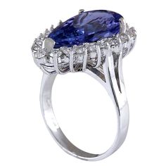 Stamped: 14K White Gold Total Ring Weight: 6.4 Grams Gemstone Weight: Total Natural Tanzanite Weight is 6.36 Carat (Measures: 17.75x9.60 mm) Color: Blue Diamond Weight: Total Natural Diamond Weight is 0.90 Carat Quantity: 21 Color: F-G, Clarity: VS2-SI1 Face Measures: 22.40x15.30 mm Sku: [702046W] Formal Tanzanite Halo Ring, Tanzanite Brilliant Cut Formal Rings, Formal Gia Certified Pear-shaped Rings, Tanzanite Halo Ring For Formal Occasions, Formal Tanzanite Halo Ring Fine Jewelry, Formal Tanzanite Rings With Prong Setting, Formal Tanzanite Diamond Ring With Center Stone, Formal White Gold Tanzanite Rings, Formal Tanzanite Diamond Ring, Oval Shape