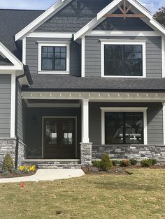 a gray house with white trim and windows