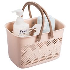 a pink plastic basket with soap, lotion and hand sanitizer in it