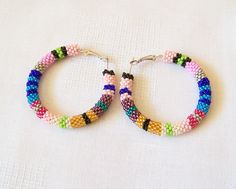 "These beaded colorful crochet hoop earrings are made using 12 colors Czech seed beads. Hoops are approximately 2\" in diameter. You can find matching Beaded Crochet Rope Necklace - Lariat in my shop: https://www.etsy.com/listing/198965374/long-beaded-crochet-rope-necklace To browse more of my Earrings please follow the link: http://www.etsy.com/shop/lutita?section_id=11451910 Return to the Lutita Shop: www.etsy.com/shop/lutita" Handmade Colorful Beaded Round Earrings, Multicolor Tiny Beads Hoop Earrings As A Gift, Multicolor Hoop Earrings With Tiny Beads As Gift, Multicolor Beaded Hoop Earrings For Gift, Multicolor Tiny Beads Small Hoop Earrings, Multicolor Hoop Earrings With Large Beads As Gift, Handmade Colorful Beaded Hoop Earrings, Handmade Rainbow Beaded Round Earrings, Multicolor Round Beaded Earrings