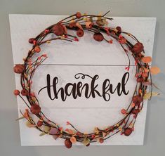 a wooden sign that says, thank with autumn leaves around it