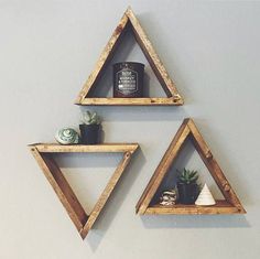 three wooden triangle shelves with plants on them