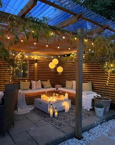 an outdoor living area is lit up with string lights