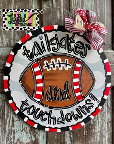 a football themed door hanger with the words tailgater and footballs on it