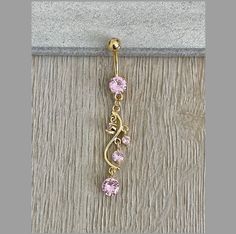 This dangly gold belly button ring features beautiful pink crystals in a long, chandelier shape. Gorgeous option for summer! Drop jaws with this body jewelry. Details & Size: ♥ Surgical Steel ♥ Cubic Zirconia ♥ Nickel Free ♥ 14G, 10mm bar ♥ Every purchase comes with an Elara gift box Please message me if you have any questions We hope you love our jewelry as much as we do! Elegant Gold Belly Rings, Dainty Gold Belly Rings For Wedding, Elegant Gold Belly Rings Gift, Elegant 14k Gold Belly Rings For Gift, Elegant 14k Yellow Gold Belly Rings, Adjustable Gold Belly Rings For Wedding, Cute Septum Rings, Gold Belly Button Ring, Unique Belly Rings