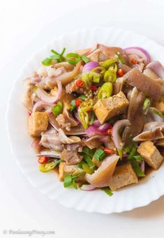 a white plate topped with meat and veggies