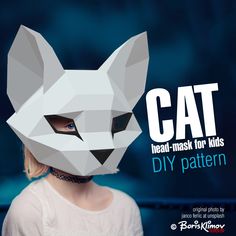 a woman wearing a paper mask with the words cat on it