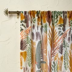 an orange and green curtain hanging on the side of a wall