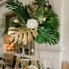 a table topped with lots of greenery and white flowers