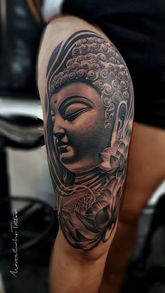 a woman's arm with a buddha tattoo on the left side of her body