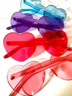 three heart shaped sunglasses sitting next to each other