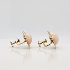 A very fine pair of Mid-Century Italian screw back earrings.  With large smooth oval cabochons framed in 18k gold rope design settings.   With screwbacks closures to the reverse.  Simply a lovely pair of Mid-Century Italian earrings!  Date: Mid-20th Century  Overall Condition: They are in overall good, as-pictured, used estate condition with some very fine & light surface scratches and other signs of expected light wear consistent with age.  Fineness: Mark 750 for gold fineness.   Marks: 750 & a Formal Gold Clip-on Cabochons, Luxury Cabochon Clip-on Earrings For Formal Occasions, Luxury Formal Clip-on Earrings With Cabochon, Formal Clip-on Earrings With Oval Cabochon, Luxury Yellow Gold Oval Clip-on Earrings, Luxury Oval Yellow Gold Clip-on Earrings, Elegant Gold Oval Cabochons, Luxury Round Cabochon Clip-on Earrings, Luxury Gold Oval Cabochon Earrings