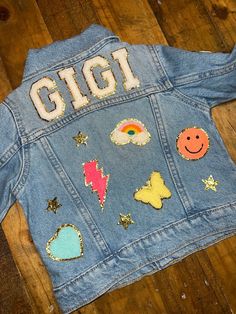 a denim jacket with patches on it that says gigi and features images of different planets