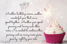 a cupcake with white frosting and sparklers on top is sitting in front of a pink background