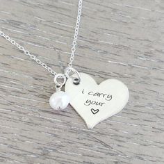 This I Carry Your Heart necklace makes for a beautiful keepsake. On this heart necklace, a 3/4" sterling silver heart pendant is hand stamped with the phrase "I carry your heart," and it hangs next to a freshwater pearl on an 18" sterling silver chain. This necklace makes a beautiful keepsake in hard times of loss. Also, this in memory necklace can be given as a sympathy gift for a miscarriage or for the loss of a loved one. * Each necklace is custom made to order. * The pain of loss is overwhel Memory Necklace, I Carry Your Heart, Sterling Silver Heart Pendant, I Carry, Memorial Necklace, Silver Heart Pendant, Engraved Jewelry, Memorial Jewelry, Hard Times