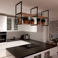 the kitchen is clean and ready for us to use it's counters are white with black trim