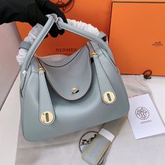 1:1 Replica Bags   Dimensions: 26 cm / 10.2 inches    This Product Is Of The Best Quality.  The Production Time Is 3-5 Working Days.  Includes Box, Dust Bag, Care Manual, Booklet, Card, Bill Of Sale…  No scarf and no pony attached Luxury Light Blue Leather Shoulder Bag, Luxury Light Blue Bags With Silver-tone Hardware, Light Blue Leather Bags With Gold-tone Hardware, Light Blue Leather Bag With Branded Hardware, Hermes Lindy, Bill Of Sale, Dust Bag, Leather, Blue