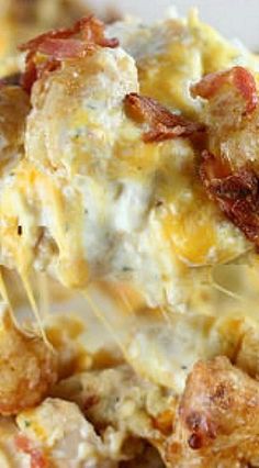 a close up of food on a plate with broccoli and cheese in the background