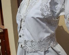 Antique Hungarian white vest with blouse hand embroidered S size If you are buying several pieces I can combine postage at the time of mailing. If you have any question please don't hesitate to contact me, My etsy shop: https://www.etsy.com/shop/TreasuryCoffer Floral Peasant Blouse, Hungarian Embroidery, White Vest, Lace Vest, Vest White, Peasant Blouse, Blouse Vintage, Embroidered Blouse, Vest Top