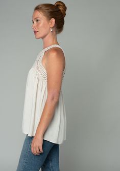 A sheer crochet-knit yoke adds a bohemian touch to this flowy tank top. Featuring a sexy racerback with a peek-a-boo keyhole detail. Perfect for festival season, we love to style this easy tank top with denim cut-offs and a simple sandal. Open knit crochet Textured floral jacquard Relaxed, flowy fit Sleeveless Crochet yoke Round neckline Racerback Back keyhole Hook & eye closure Bohemian crochet tank top Model is 5'9, wearing a size S.Style: I-13907W-RTW Casual Camisole For Festival, Bohemian Crochet Camisole Top For Summer, Bohemian Camisole Crochet Top For Summer, Bohemian Sleeveless Crochet Top For Day Out, Vacation Tank Crochet Top, Chic Crochet Trim Tank Top For Day Out, Bohemian Lace Camisole Top, Bohemian Crochet Lace Tank Top, Bohemian Camisole Top With Lace Trim