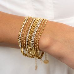 The Hot Shot Bracelet is a stunning triple-stand bracelet that combines daintiness and sparkle seamlessly. Available in both silver and gold, it is the perfect accessory to add a touch of sparkle and texture. Its versatility and balance make it a must-have for any jewelry collection. 18k gold plated over stainless steel Water/tarnish-resistant 6.5" plus 1" extender length Choose Color Below Stack and layer to replicated as seen on our styled on image