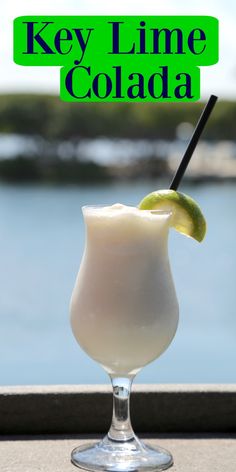 a drink in a glass with a lime on the rim and text that reads key lime cola