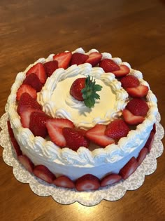 there is a cake with strawberries on the top and frosting in the middle