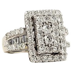 a white gold diamond ring with two rows of diamonds on the band and one row of baguetts