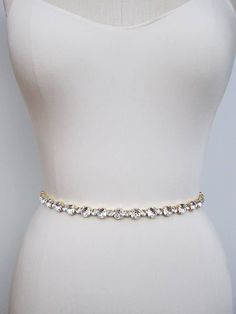 "This elegant sparkly bridal belt is made with the finest Swarovski crystals beaded on a 1/4\" wide double face satin ribbon. The crystal part of the belt measures 12 1/2\" long and 7/16\" wide. The entire sash measures 150\" long. Available in gold or silver finish. Made with the highest quality fine jewelry grade crystals. - This belt can be made in any length. Please inquire about the specific length and pricing - For the photo of the ribbon color options, please take a look here: https://www Elegant Crystal Bridal Belt, Elegant Gold Bridal Accessories With Sashes, Glamorous Wedding Bridal Belt With Crystals, Formal Bridal Belt With Crystal Sashes, Formal Crystal Bridal Belt With Sashes, Crystal Bridal Belt With Sashes For Party, Elegant White Belt With Rhinestones, Party Crystal Bridal Accessories With Sashes, Elegant Crystal Wedding Sashes