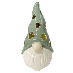 a ceramic gnome's hat with gold leaves on it