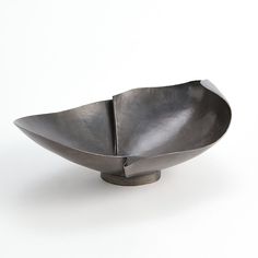 a metal bowl sitting on top of a white table