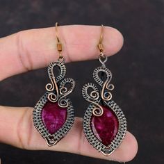 Note : Due to the natural formation of this gemstone. Slight variation in design and color are to be expected.  Faceted Kashmir Ruby Earring Copper Wire Wrapped Earrings Handmade Copper Jewelry Gift For Women Genuine Gemstone Earring Brand New Jewelry Handmade Copper Earrings SKU : VFWE-135 Gemstone : Kashmir Ruby Stone Shape : Oval    Metal Purity : Copper Earrings Length : 70 MM   Earrings Width : 21 MM Gives Mental Strength. Due to its association with the Sun, ruby gemstone is aptly called the king of gems. ... Improves Paternal Relationships. ... Brings Name and Fame. ... Wards off the Evils. ... Commands Authority and Luxury. ... Rejuvenates Health Conditions. ... Increases Marital Harmony. Ruby Earring, Handmade Copper Jewelry, Bijoux Fil Aluminium, Copper Jewelry Handmade, Diy Jewelry Inspiration, Wrapped Earrings, Mental Strength, Ruby Earrings, Ruby Stone