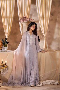 SKU:- 2315 Price for Shirt and inner only. This ethereal maxi dress is crafted from luxurious chiffon fabric adorned with intricate thread embroidery, embellished with shimmering pearls, enchanting French knots, and delicate beading.This festive ensemble is an absolute essential for the Eid season, showcasing agraceful flow and an exquisite blend of embellishments. The two-toned dupattaelegantly complements the overall look, elevating the ensemble to a sublime fashionstatement that captures the Elegant Long Gown For Reception, Elegant Festive Maxi Dress With Sheer Dupatta, Elegant Georgette Maxi Dress For Wedding, Elegant Maxi Dress With Dupatta For Festive Occasions, Elegant Georgette Gown With Chikankari Embroidery, Georgette Maxi Dress With Sheer Dupatta For Eid, Sheer Dupatta Maxi Dress For Eid Party, Elegant Maxi Gown With Resham Embroidery, Floor-length Lace Dresses For Eid