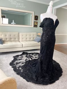 a black evening gown on display in a living room