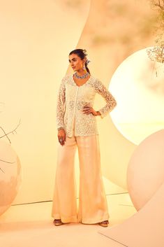 Featuring a pearlwork hand-embroidered jacket with flared pants. It comes with a bralet From Aneesh Agarwaal's Naksh collection. DELIVERY TIMEPlease allow 8-12 weeks for your outfit to arrive. FABRIC DETAILSPants, Satin Organza, Jacket-Tulle Professional cleaning only. Evening Party Wear Sets With Pearl Embroidery, Evening Sets With Pearl Embroidery For Party Wear, Fitted Sets With Pearl Embroidery For Designer Wear, Party Wear Long Sleeve Embellished Sharara, Party Wear Embellished Long Sleeve Sharara, Elegant Palazzo Set With Pearl Embroidery For Parties, Long Sleeve Embellished Sharara For Party Wear, Embellished Long Sleeve Sharara For Party Wear, Elegant Fitted Palazzo Set With Pearl Embroidery