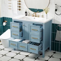 a bathroom with a sink, toilet and blue cabinet drawers in the middle of it