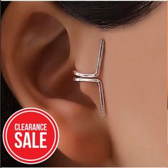 a pair of earrings with the word clearance sale written on it and an image of a woman's ear