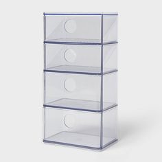 three clear drawers stacked on top of each other in front of a white background,