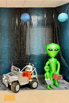 an alien themed room with two toy vehicles