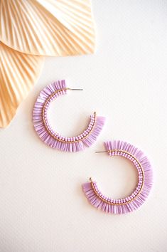 The Gracie Rattan Fan Hoops are the perfect accessory to elevate your tropical vacation style. These colorful rattan hoop earrings exude a playful and vibrant charm that complements any summertime outfit. Handcrafted with intricate attention to detail, each earring features a unique fan-shaped design, adding a touch of whimsy and exotic flair. Made from sustainable rattan material, these lightweight hoops provide a comfortable fit without compromising on style. Whether you're strolling along the Trendy Hoop Earrings For Vacation, Spring Vacation Hoop Earrings, Handmade Hoop Earrings For Summer Vacation, Bohemian Small Hoop Earrings For Vacation, Pink Hoop Earrings For Beach And Spring Season, Pink Hoop Earrings For The Beach, Trendy Small Hoop Earrings For The Beach, Pink Hoop Earrings For Spring Beach Occasions, Pink Hoop Earrings For Beach During Spring