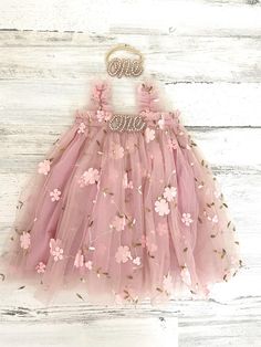 This listing if for a vintage pink  floral tutu dress!  Perfect for that 1st birthday!!  *This dress comes as is (with no "one")- "Dress only" option from the drop down menu Dress with one (just the one dress) One Dress with headband   ~headband elastic can be made in any color! ~ ships within 1 to 3 business days (message me with any additional questions)! ~ headband backed with felt for comfort {{SIZING}}  6-9 months (fits 18-20 lbs.) 9-12 months (fits 20-22 lbs.) 12-18  months  (fits 22-26 lb Princess Tutu Dress With Floral Applique For Birthday, Princess Style Tutu Dress With Floral Applique For Birthday, Pink Tutu Dress With Floral Applique For Summer, Cute Fairy Dress For First Birthday In Spring, Birthday Tutu Dress With Floral Applique, Pink Fairy Dress For First Birthday Spring, Cute Fairy Dress For Summer Birthday, Summer Fairy Dress With Ruffles For First Birthday, Whimsical Pink Tutu Dress With Floral Applique