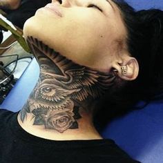 a woman with a tattoo on her neck is laying down and looking up at the sky