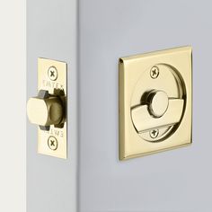 a close up of two different knobs on a wall